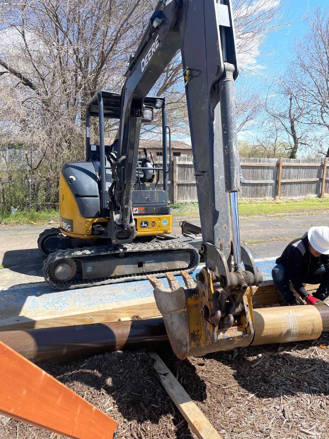 Foundation repair crew working at a brick residential property in Oklahoma