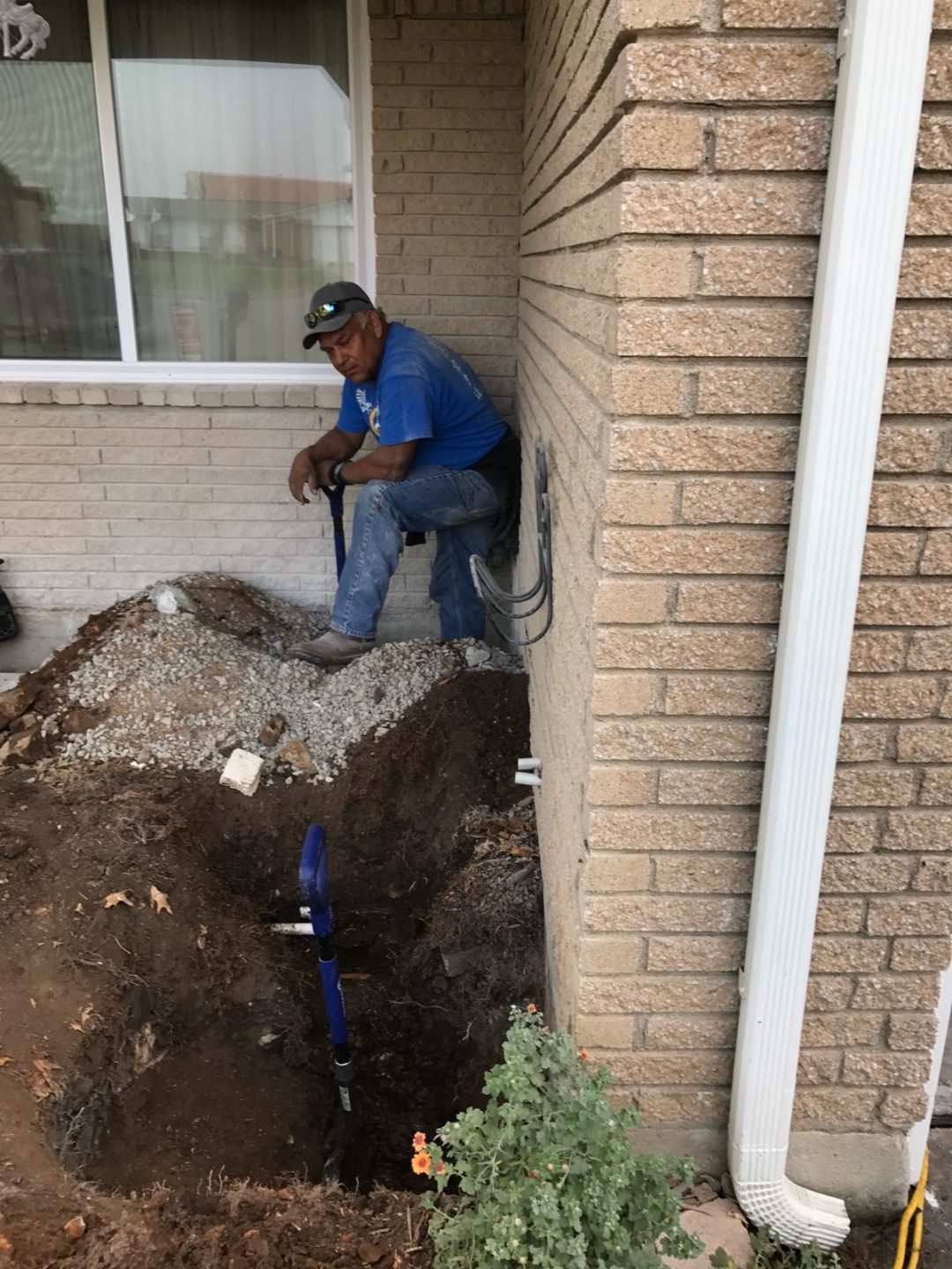 Foundation perimeter trench prepared for moisture-management and waterproofing work